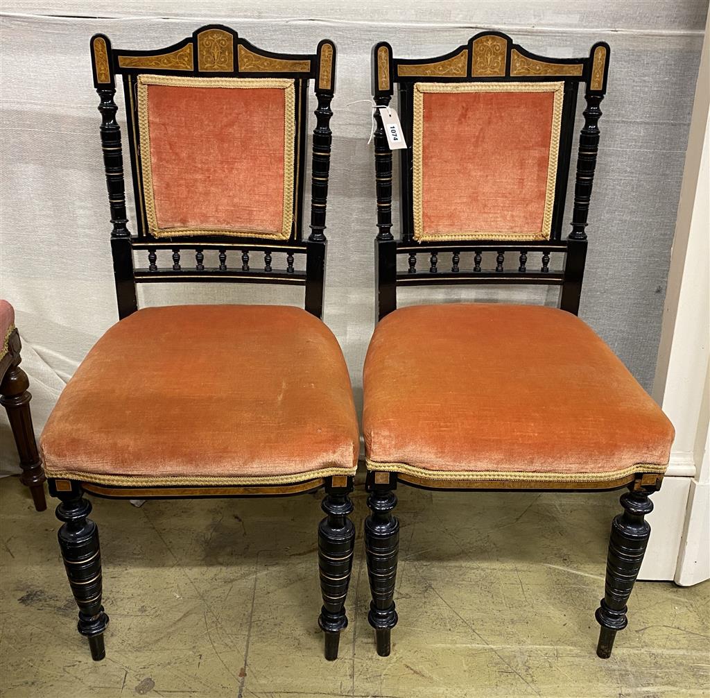 A pair of late Victorian marquetry inlaid ebonised side chairs